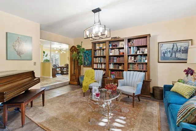 a view of a livingroom with furniture and a bookshelf