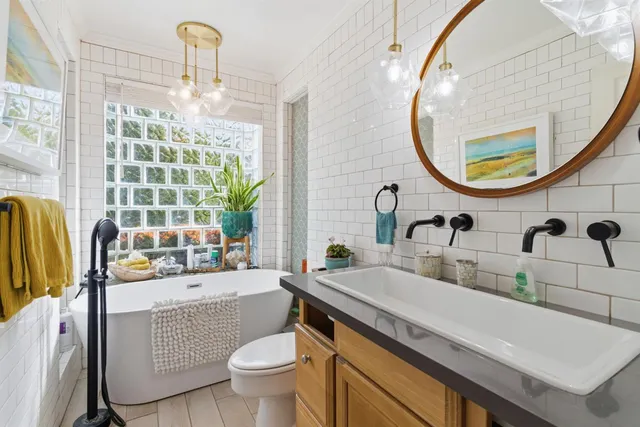 a bathroom with a sink a toilet and a mirror