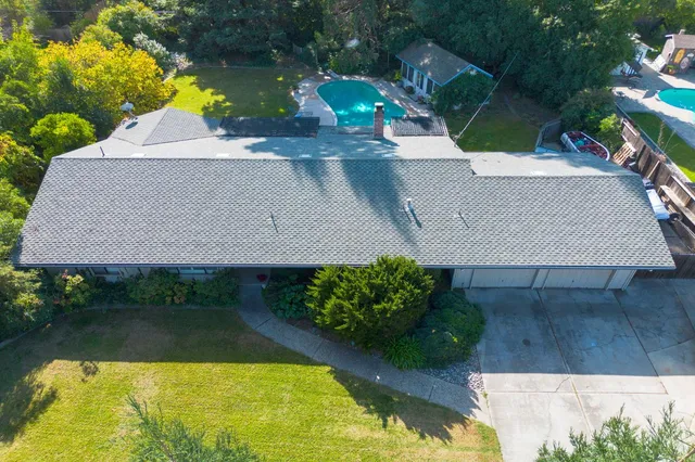 an aerial view of a house with swimming pool