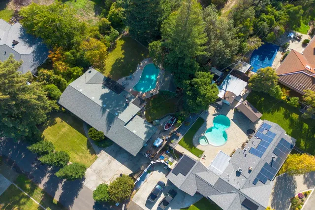 an aerial view of a house with a swimming pool