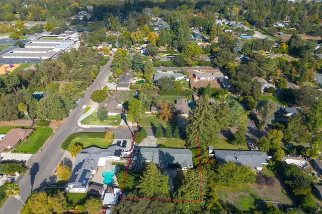 an aerial view of residential houses with outdoor space
