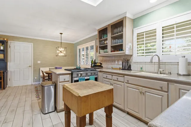 a kitchen with a sink stove and cabinets