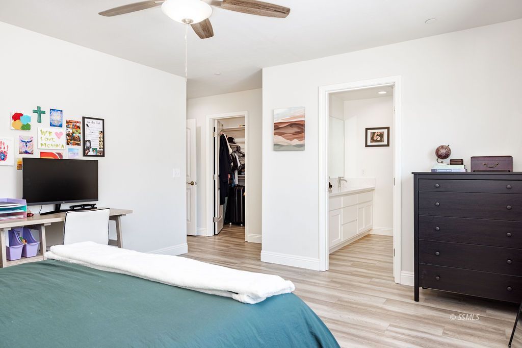 1229 South Ranger Street Ridgecrest, CA 93555 - Photo 23 of 36 a bedroom with a workspace and a flat screen tv