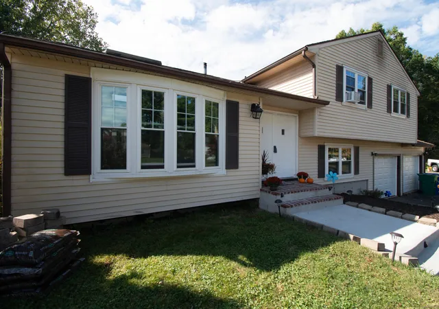 a front view of a house with a garden and patio