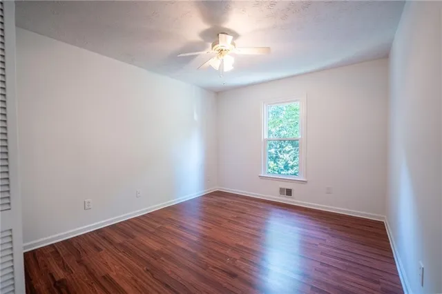 a view of room with window and hardwood floor