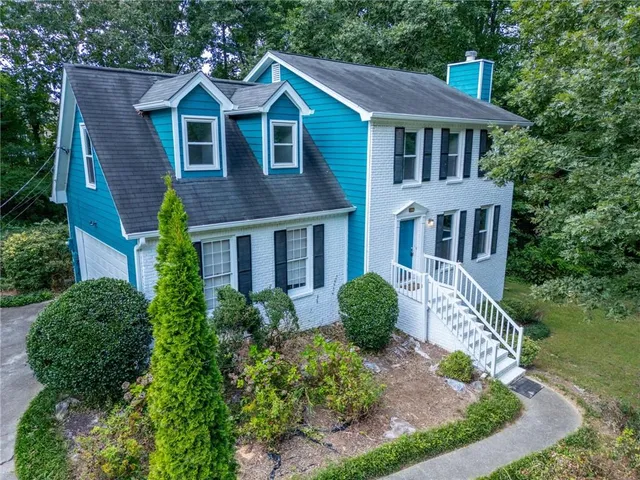 a front view of a house with garden