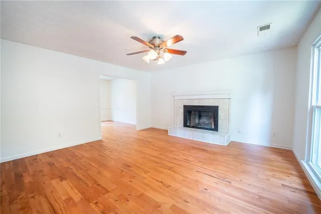 a view of empty room with a fireplace