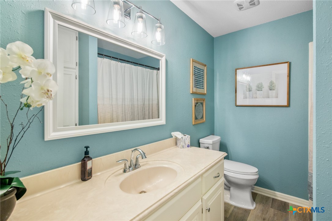 119 Larimore Street Victoria, TX 77904 - Photo 14 of 19 a bathroom with a sink a toilet and mirror