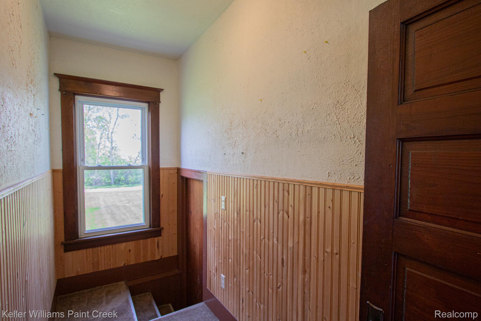 2165 Michigan Road Port Huron, MI 48060 - Photo 20 of 38 Entryway with wainscoting and a textured wall