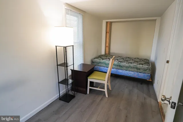 a bedroom with a bed and a desk
