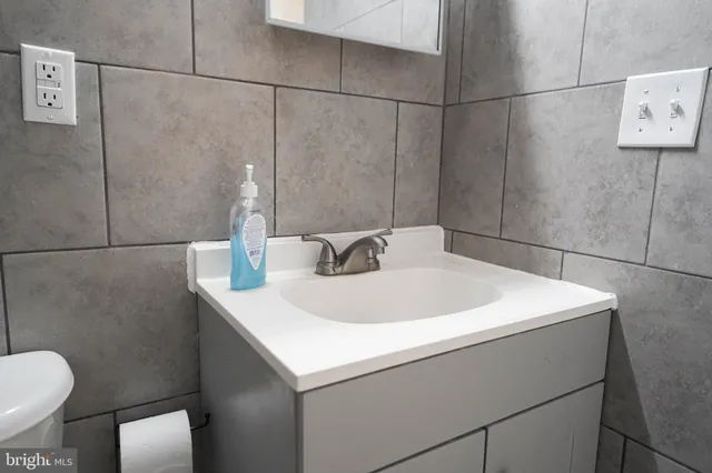 a close view of a sink and a toilet in a bathroom