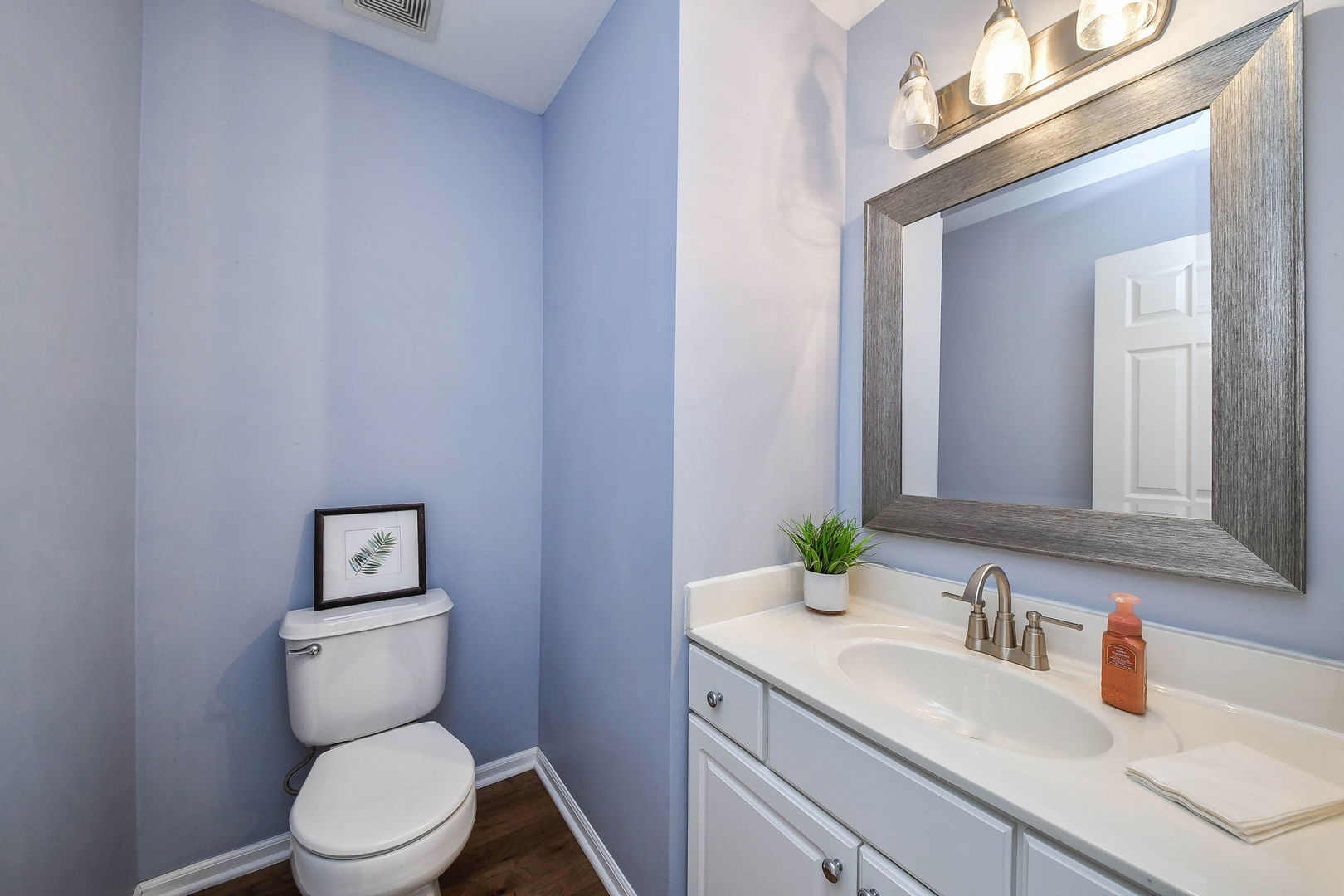 1772 Ellington Drive Aurora, IL 60503 - Photo 11 of 24 a bathroom with a toilet sink and mirror