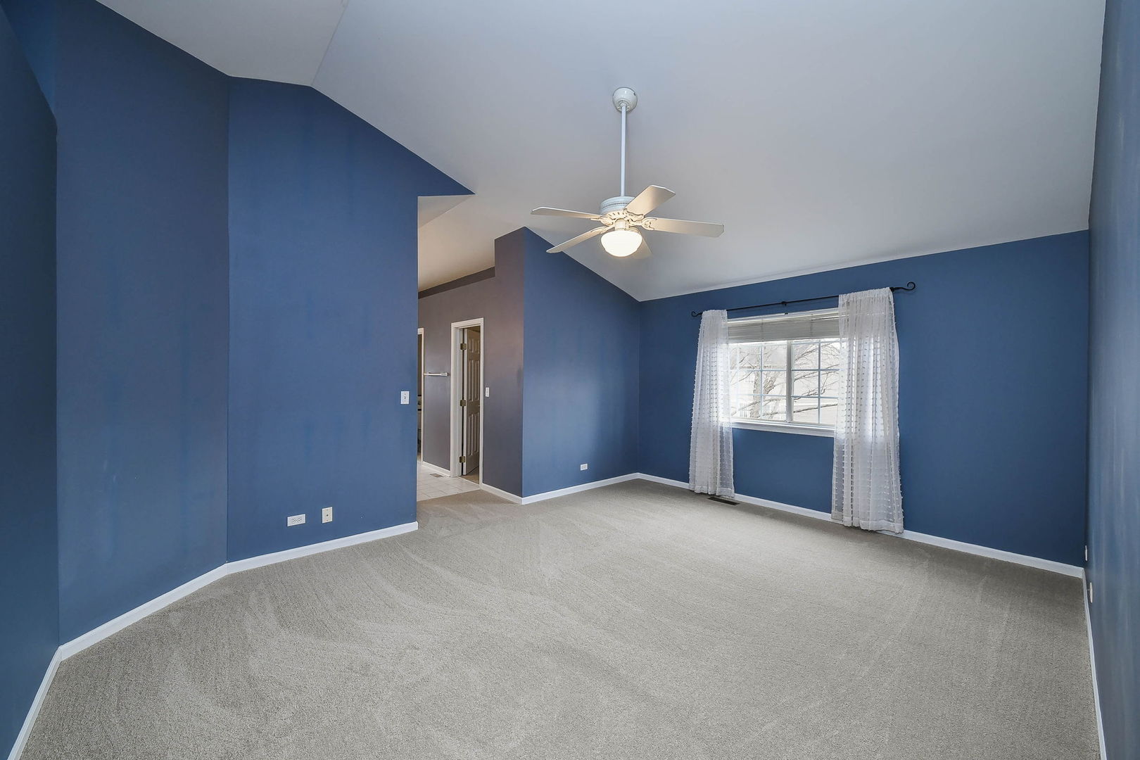 1772 Ellington Drive Aurora, IL 60503 - Photo 13 of 24 an empty room with a chandelier fan and windows