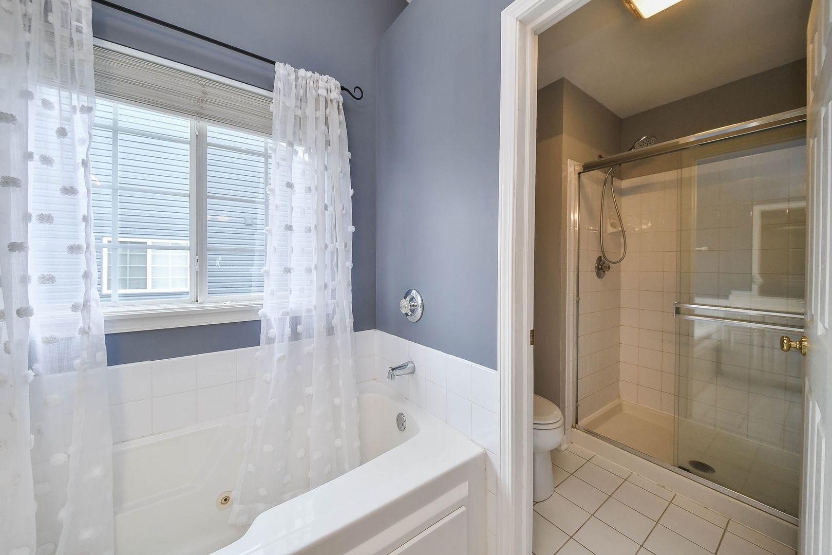 1772 Ellington Drive Aurora, IL 60503 - Photo 15 of 24 a bathroom with a bathtub and a shower