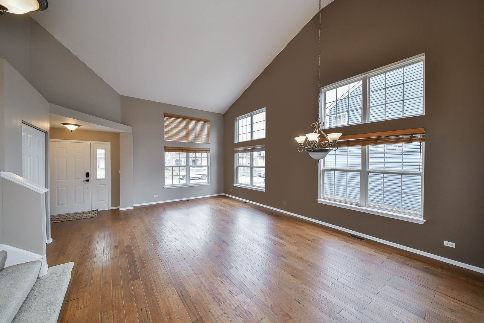 1772 Ellington Drive Aurora, IL 60503 - Photo 3 of 24 a view of an empty room with wooden floor and a window