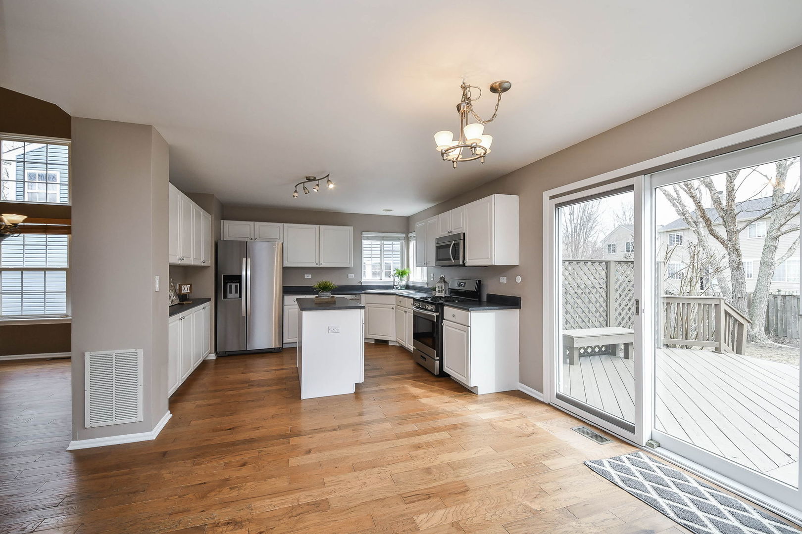 1772 Ellington Drive Aurora, IL 60503 - Photo 5 of 24 a kitchen with kitchen island granite countertop a refrigerator cabinets and wooden floor