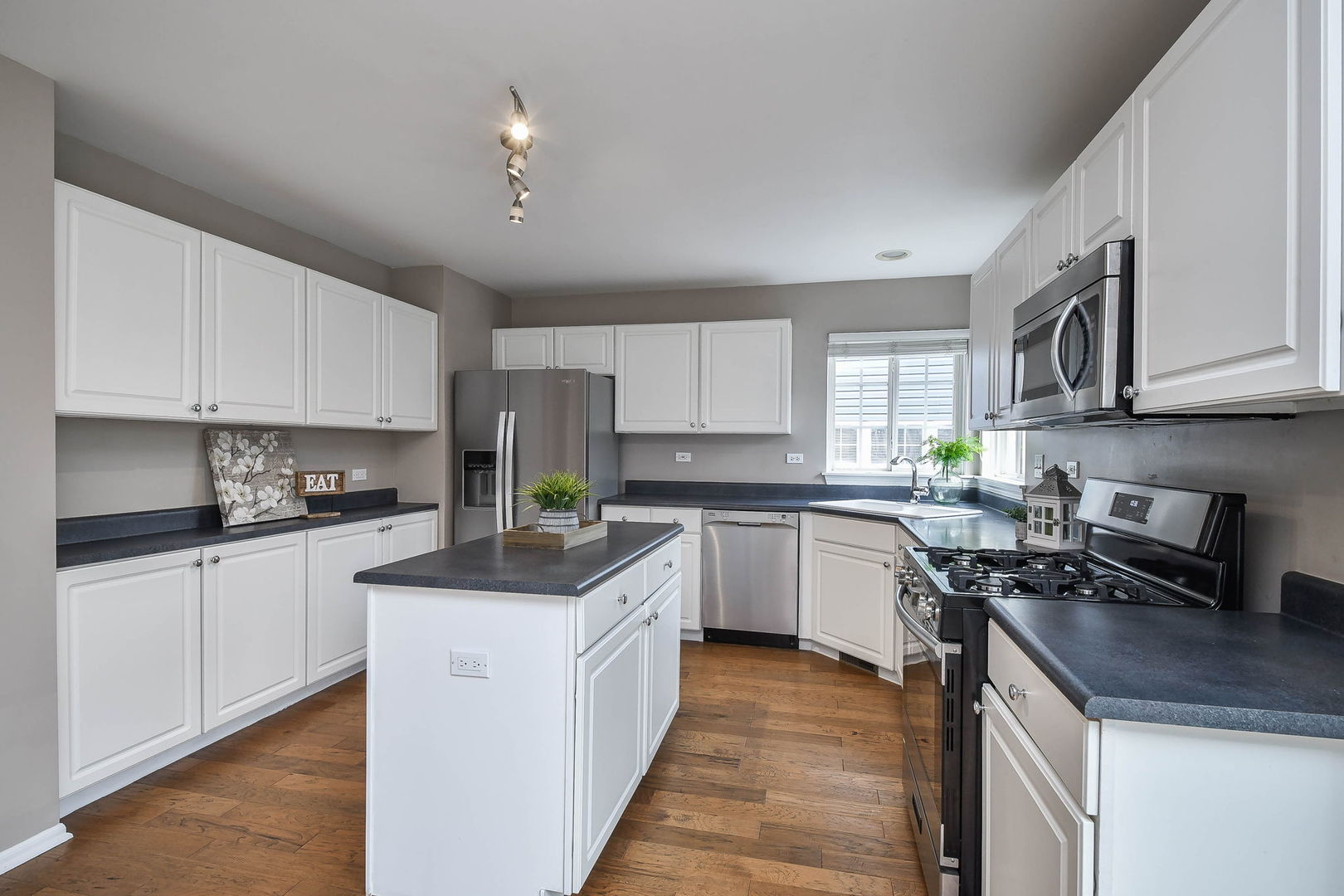 1772 Ellington Drive Aurora, IL 60503 - Photo 6 of 24 a kitchen with stainless steel appliances granite countertop a sink stove and refrigerator