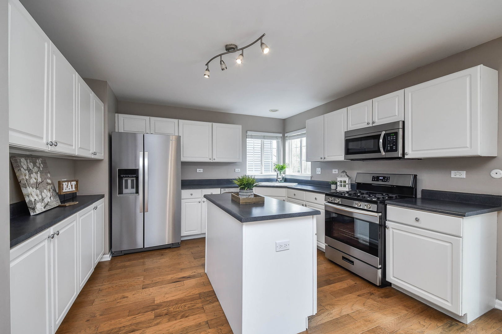 1772 Ellington Drive Aurora, IL 60503 - Photo 7 of 24 a kitchen with stainless steel appliances granite countertop a stove top oven a refrigerator a sink and dishwasher with white cabinets