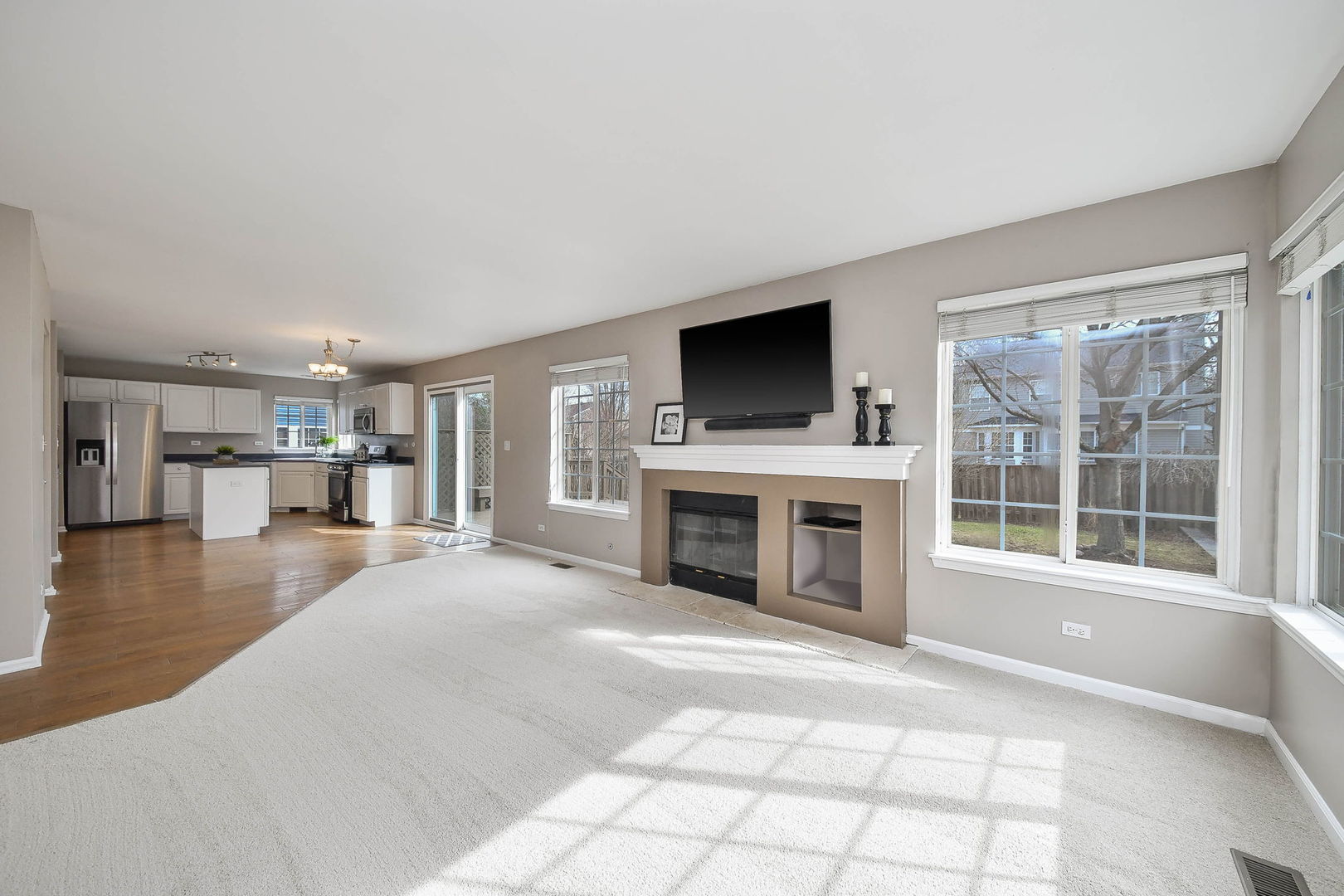 1772 Ellington Drive Aurora, IL 60503 - Photo 9 of 24 a view of a livingroom with a fireplace a flat screen tv and windows