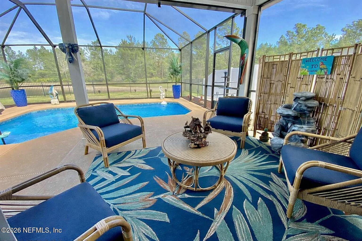 115 Sierras Loop St. Augustine, FL 32086 - Photo 6 of 65 a living room with furniture and a floor to ceiling window