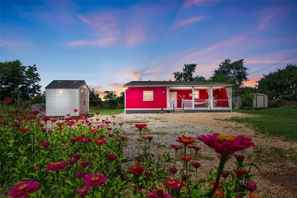 a view of a house with a yard and garden
