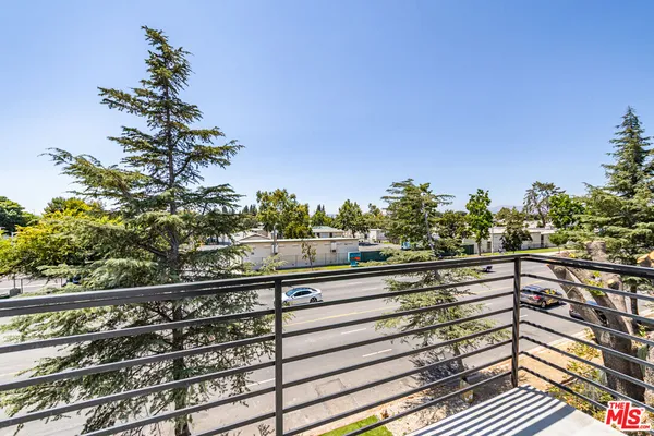 a view of a balcony with wooden floor and outdoor space