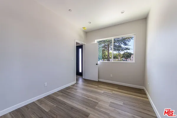 a view of room with window and wooden floor