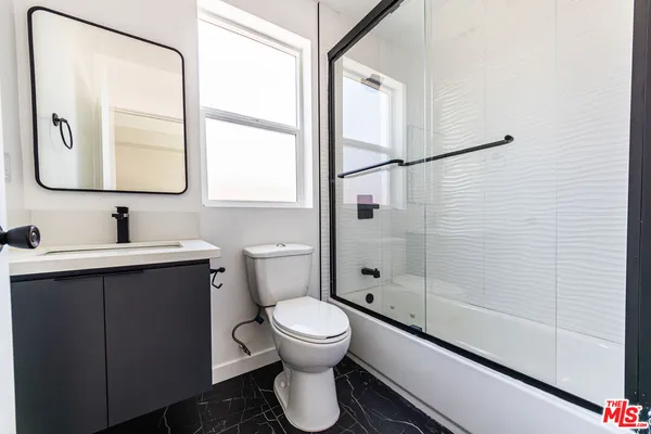 a bathroom with a toilet sink and a shower