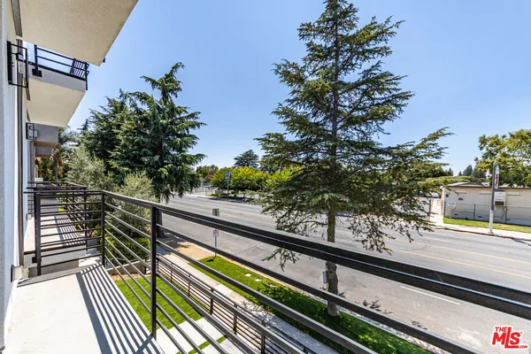 a view of balcony with wooden floor and fence