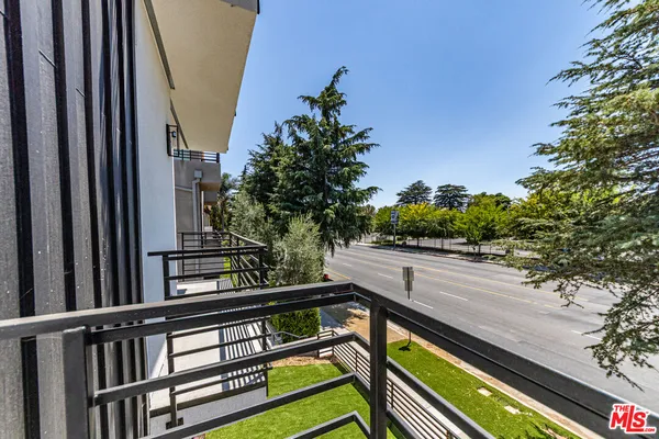 a view of balcony with wooden floor and fence
