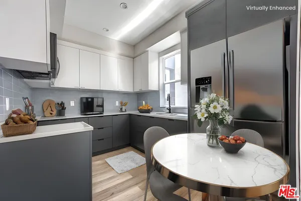 a kitchen with a refrigerator and a sink