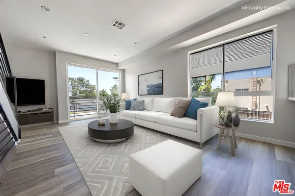 a living room with furniture a flat screen tv and a large window