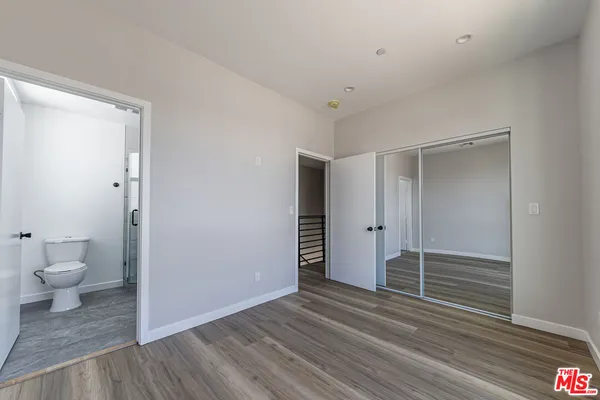 a view of a bathroom with wooden floor and a toilet