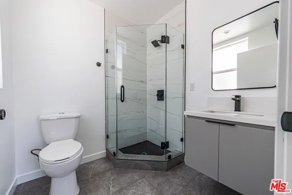 a bathroom with a toilet sink and shower