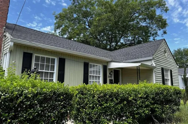 an empty room with wooden floor and fireplace