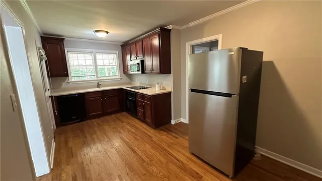a kitchen with stainless steel appliances granite countertop a stove and a refrigerator