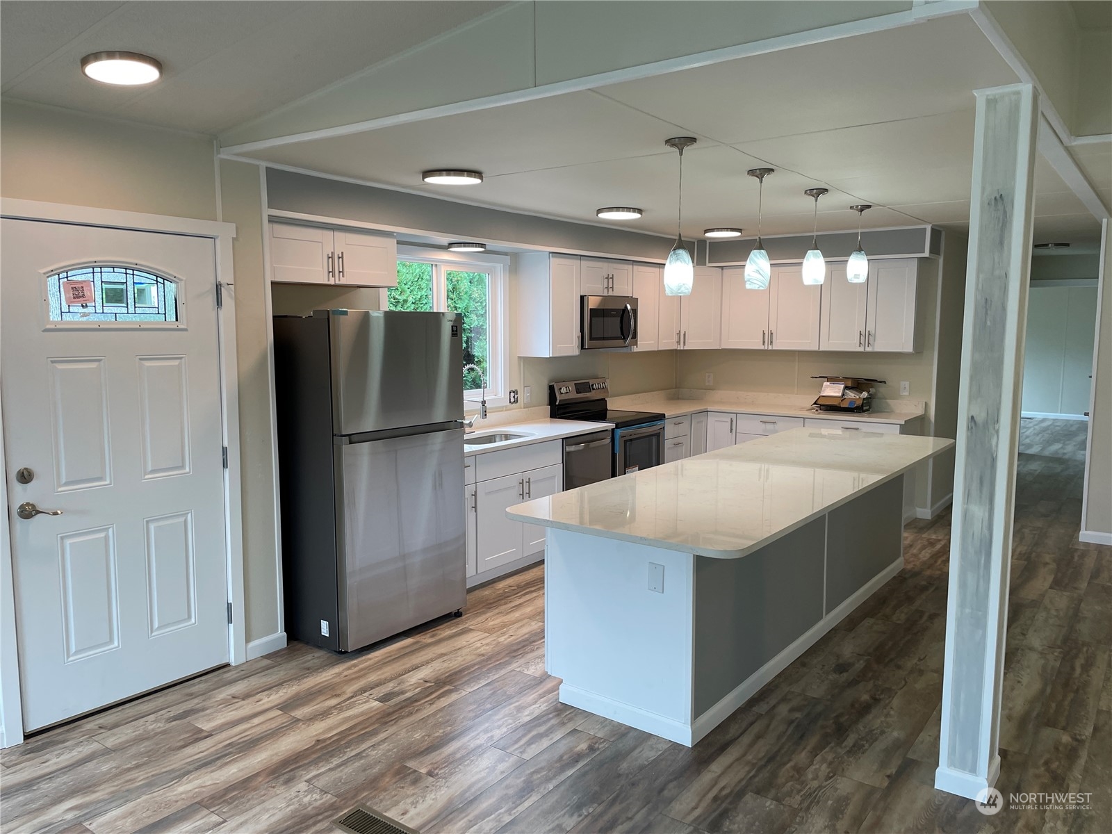 201 Union Avenue Southeast, Unit 134 Renton, WA 98059 - Photo 6 of 20 a kitchen with stainless steel appliances granite countertop a refrigerator a sink and a stove