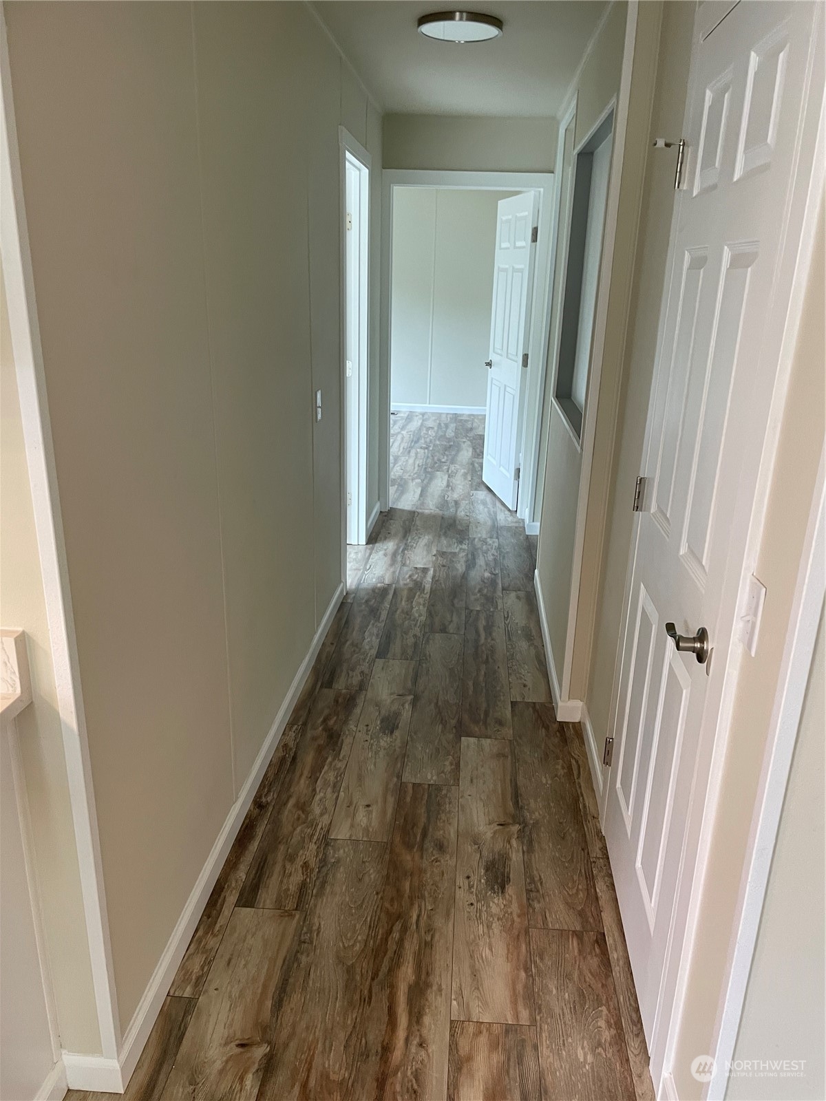 201 Union Avenue Southeast, Unit 134 Renton, WA 98059 - Photo 10 of 20 a view of a hallway with wooden floor and staircase