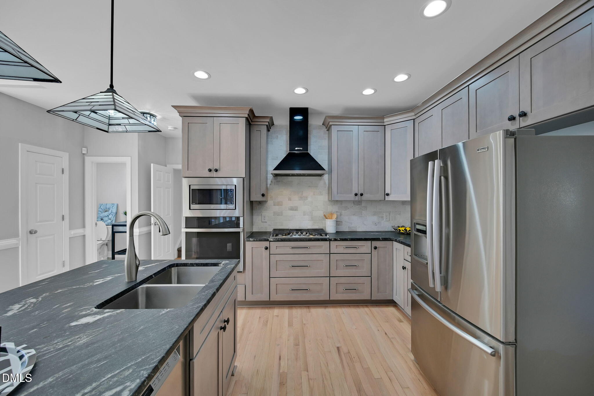 8005 Looking Glass Court Raleigh, NC 27612 - Photo 12 of 75 a kitchen with kitchen island granite countertop stainless steel appliances cabinets a sink and a counter top space