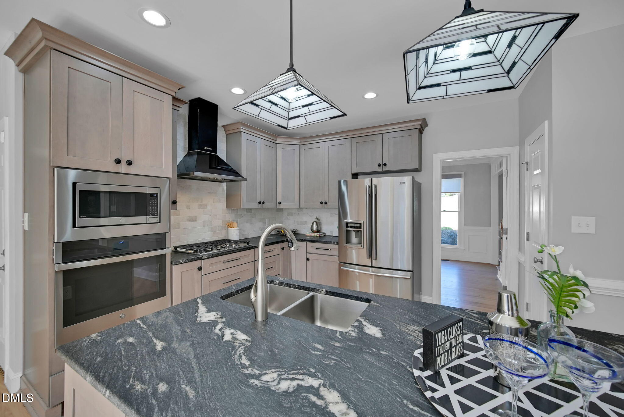 8005 Looking Glass Court Raleigh, NC 27612 - Photo 14 of 75 a kitchen with stainless steel appliances granite countertop a refrigerator a stove and a sink with wooden floor