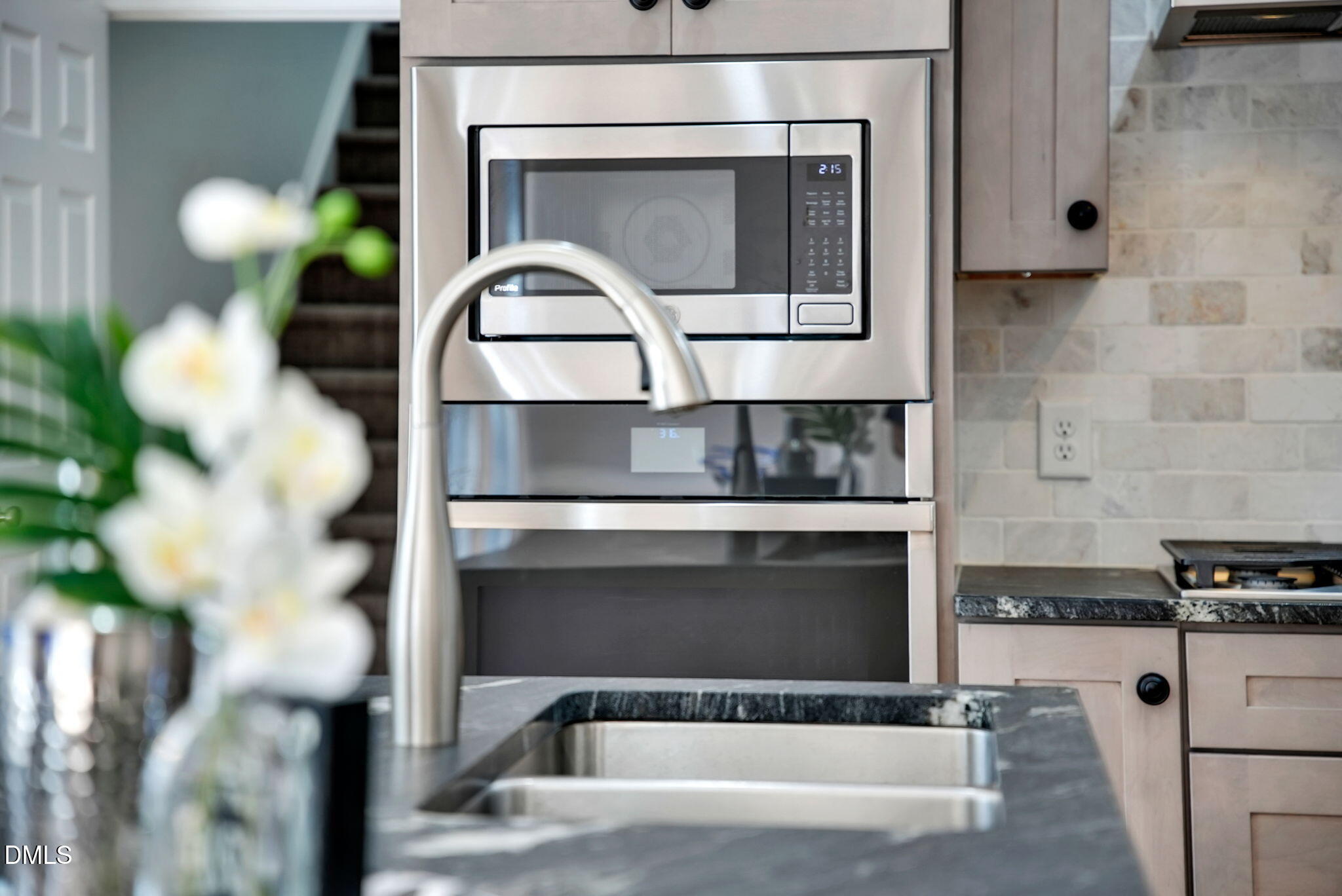 8005 Looking Glass Court Raleigh, NC 27612 - Photo 16 of 75 a living room with a fireplace and a potted plant