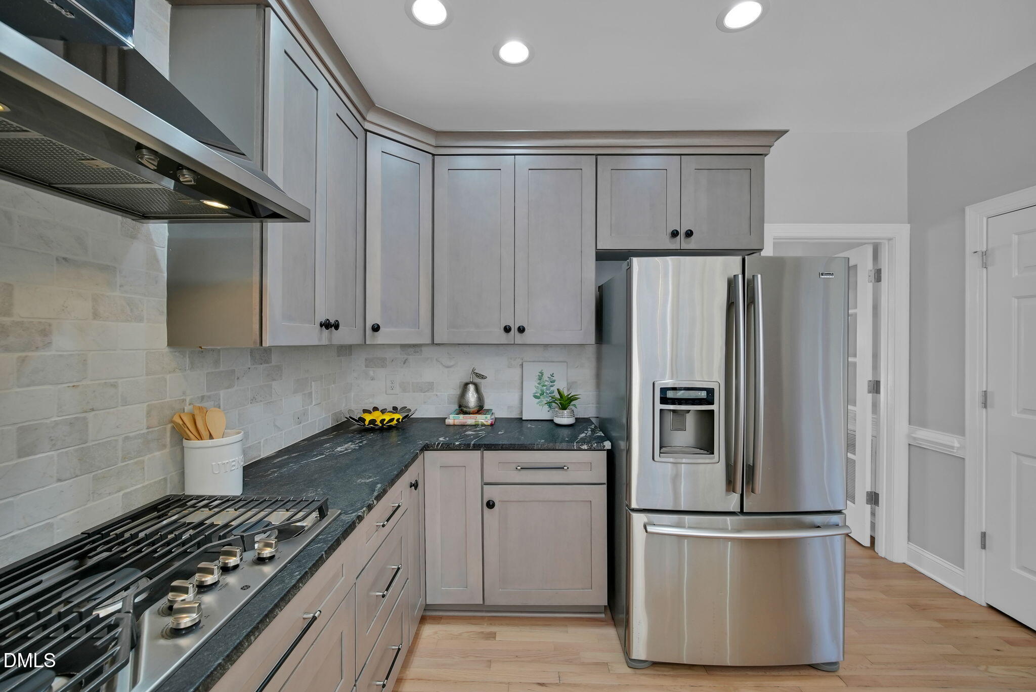 8005 Looking Glass Court Raleigh, NC 27612 - Photo 17 of 75 a kitchen with cabinets and stainless steel appliances