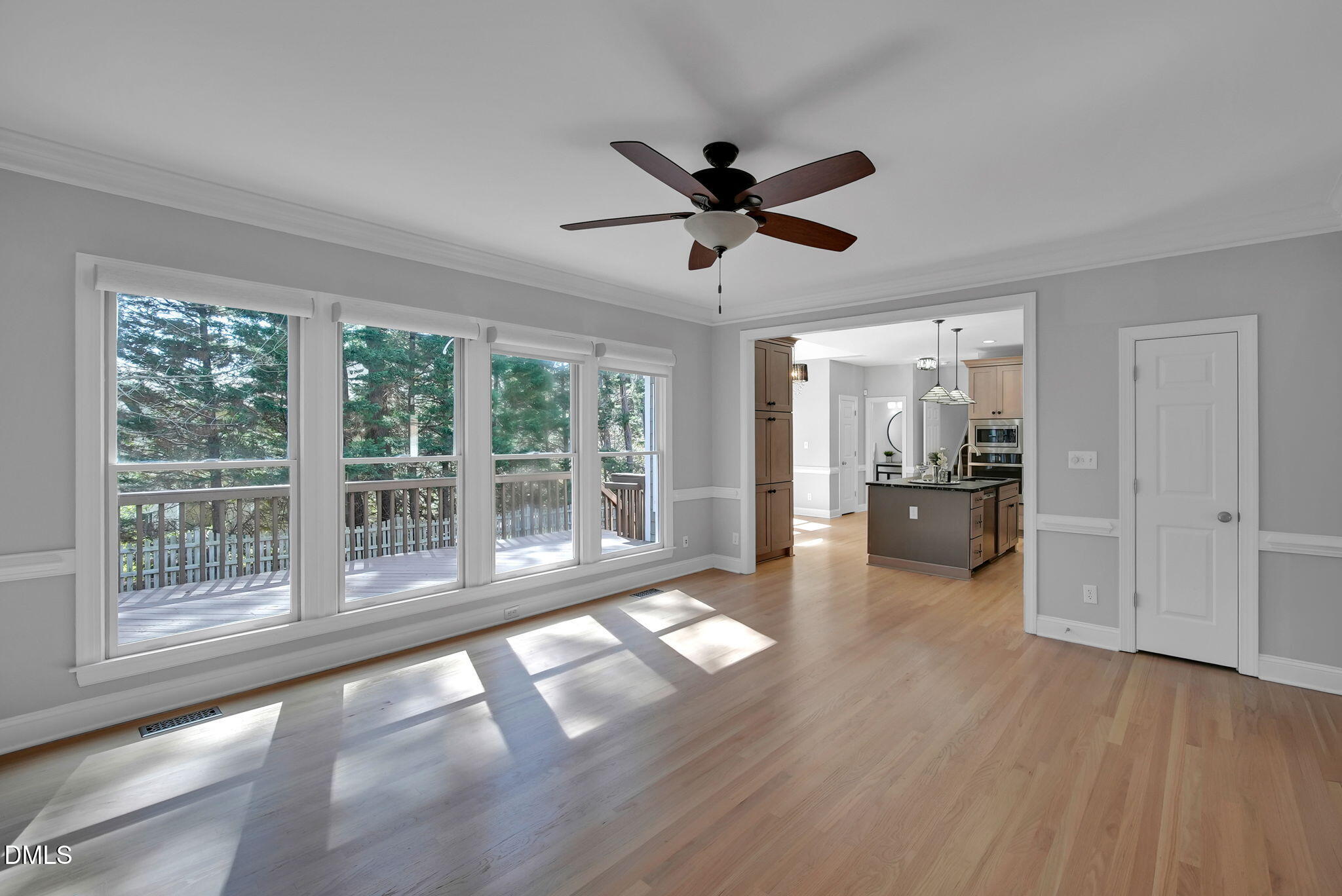 8005 Looking Glass Court Raleigh, NC 27612 - Photo 22 of 75 a view of empty room with wooden floor and fan