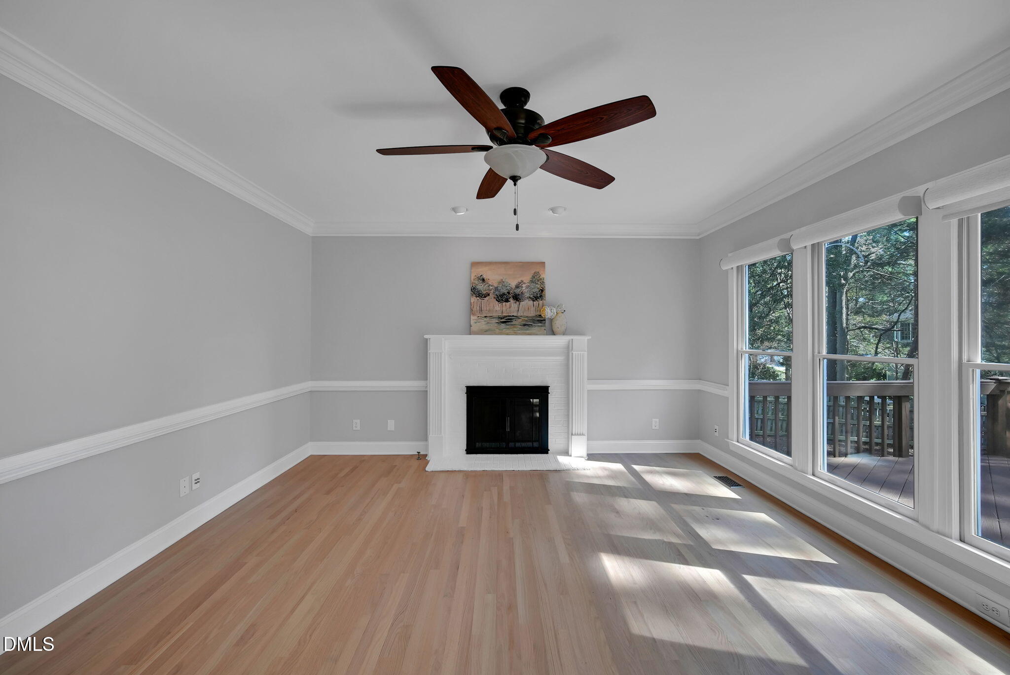 8005 Looking Glass Court Raleigh, NC 27612 - Photo 23 of 75 a view of wooden floor a chandelier and a fireplace in a room