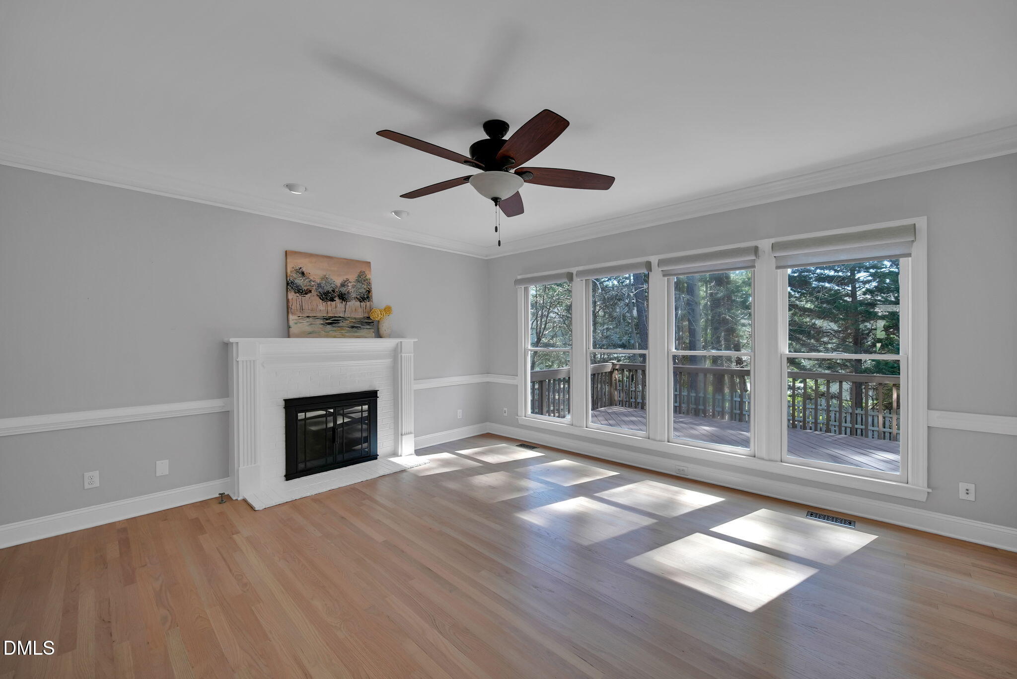 8005 Looking Glass Court Raleigh, NC 27612 - Photo 24 of 75 a view of empty room with wooden floor and fireplace