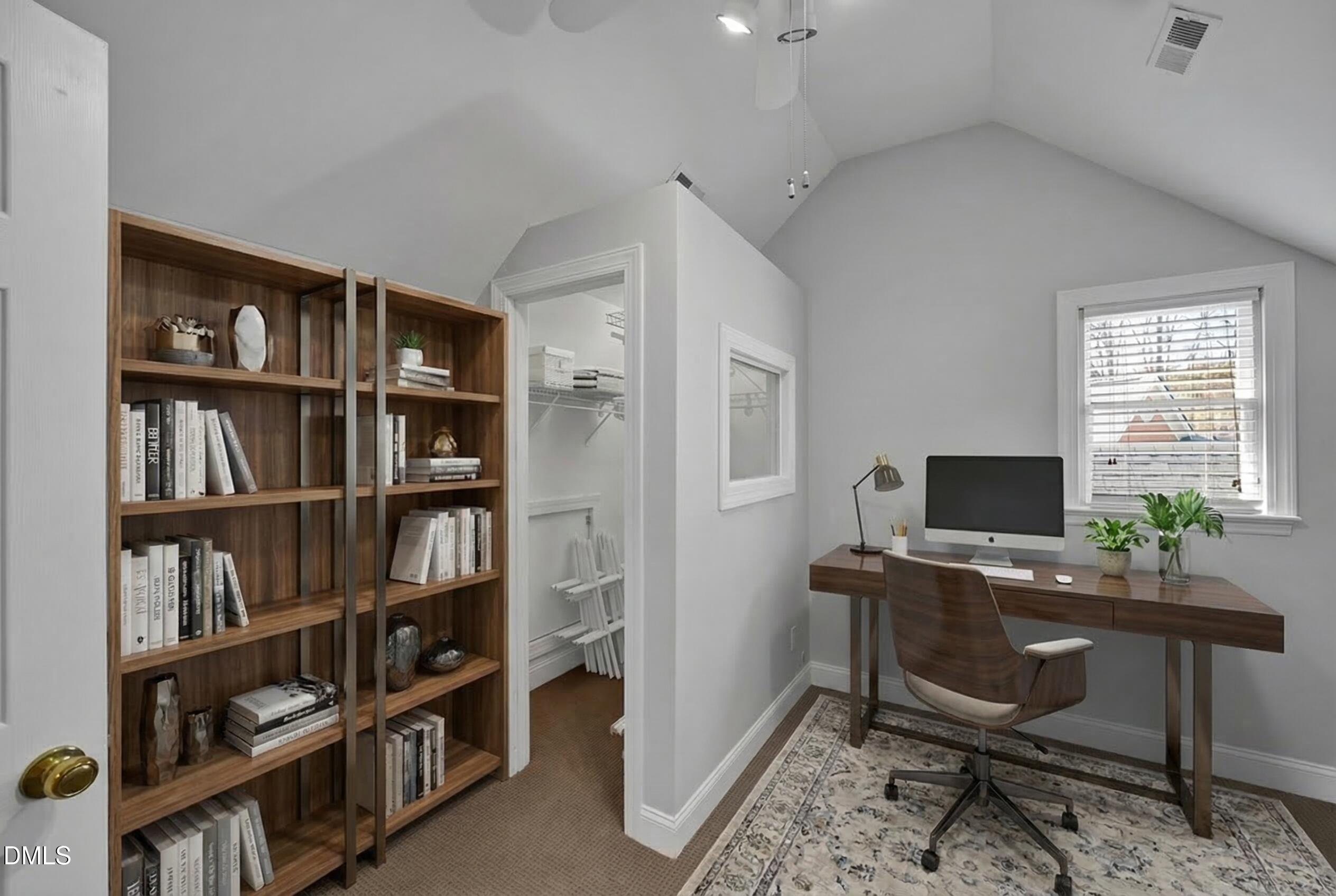 8005 Looking Glass Court Raleigh, NC 27612 - Photo 33 of 75 a view of a workspace with furniture and a bookshelf