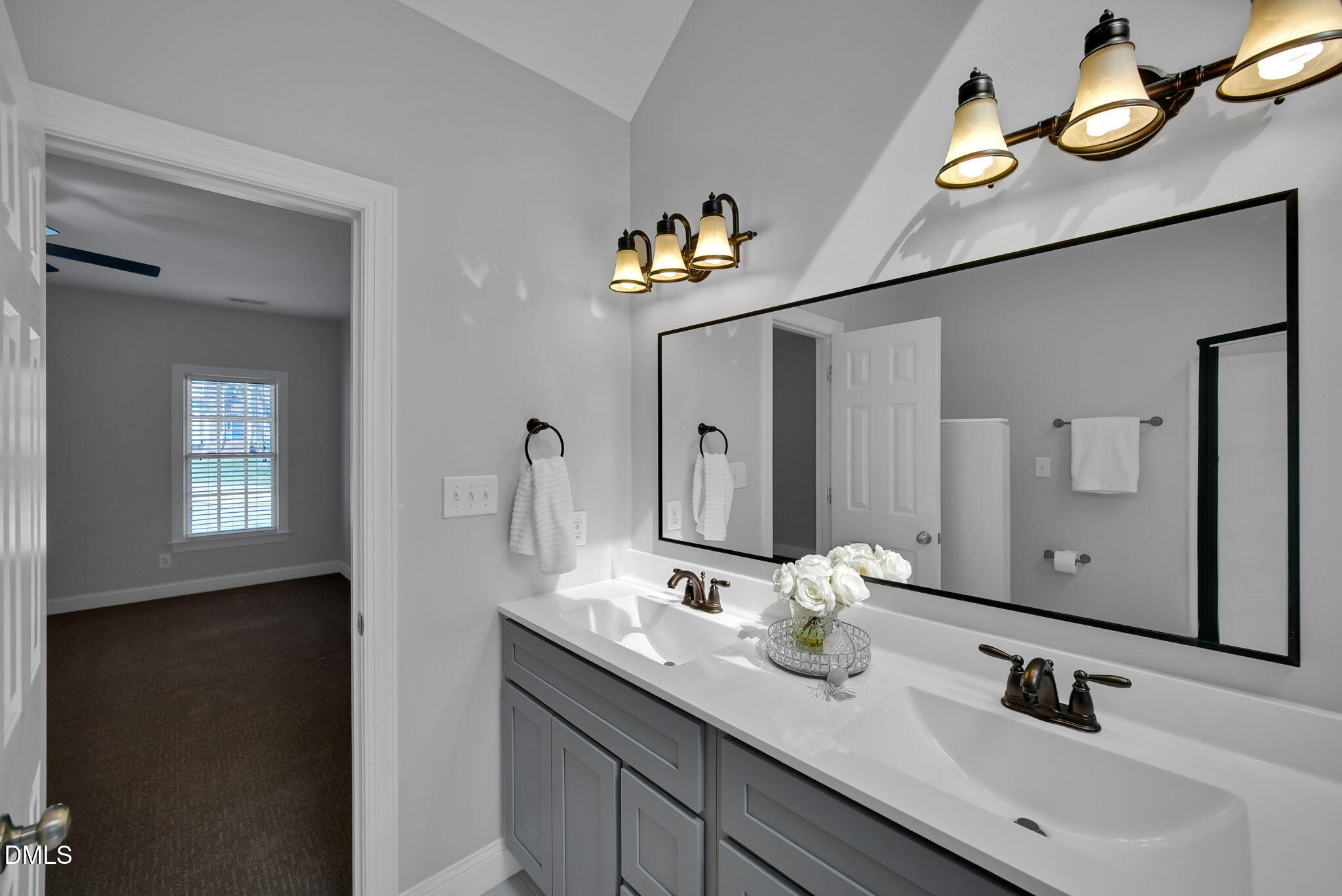 8005 Looking Glass Court Raleigh, NC 27612 - Photo 38 of 75 a bathroom with a double vanity sink and mirror