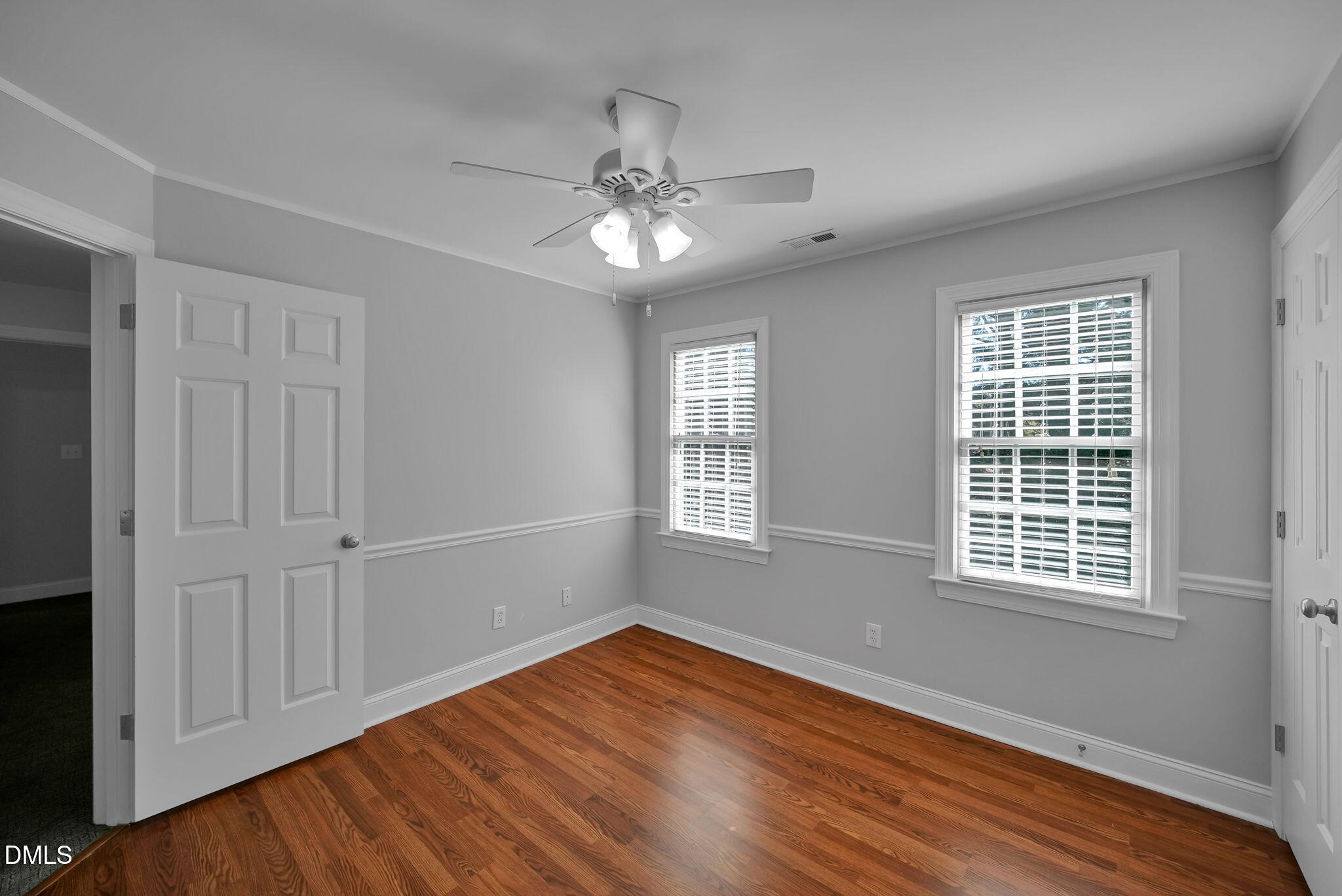 8005 Looking Glass Court Raleigh, NC 27612 - Photo 48 of 75 a view of an empty room with wooden floor and a window
