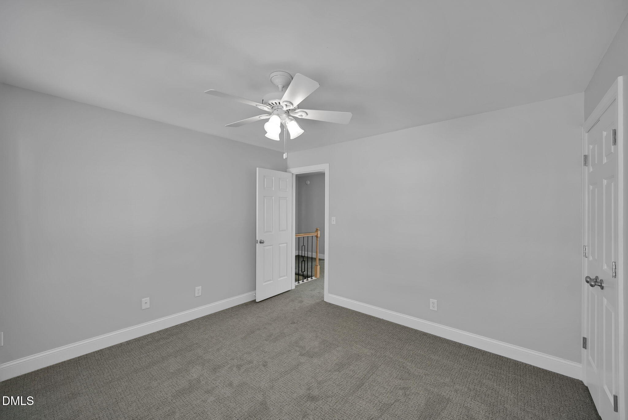 8005 Looking Glass Court Raleigh, NC 27612 - Photo 49 of 75 an empty room with a ceiling fan and a window