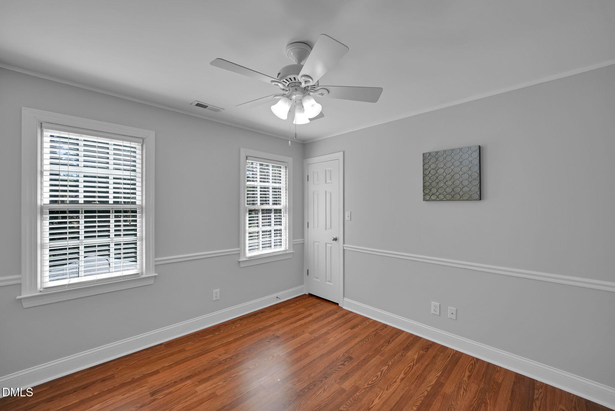 8005 Looking Glass Court Raleigh, NC 27612 - Photo 53 of 75 a view of an empty room with wooden floor and a window